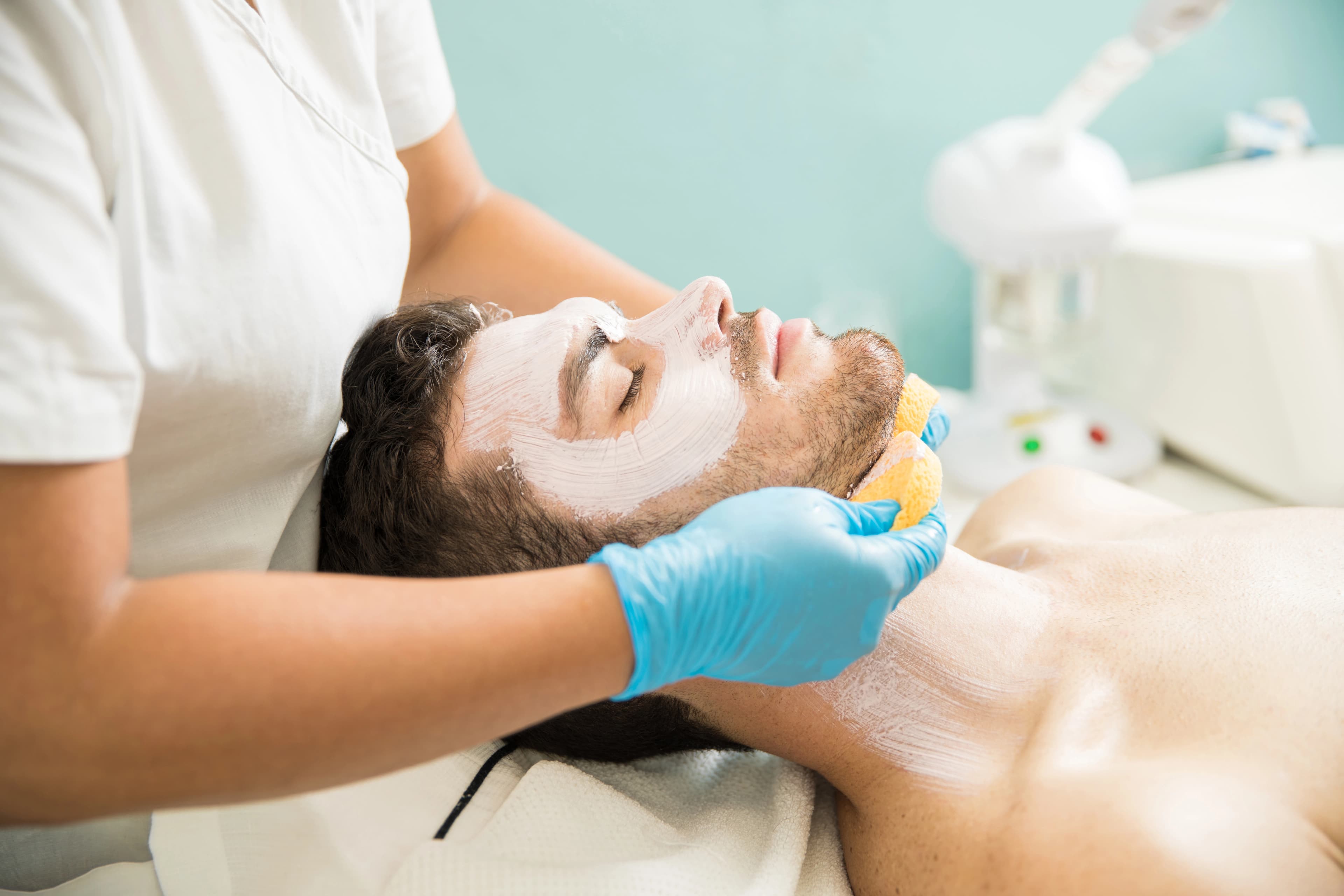 Male patient receiving a clinical deep-cleansing facial